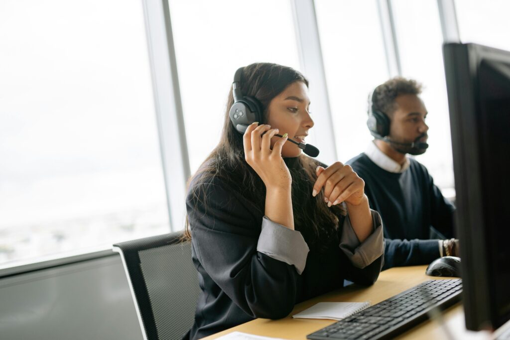 Professional answering service operator wearing a headset at a desk